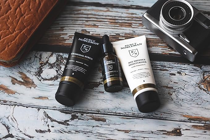 Percy Nobleman Age Defence Kit, a men's skincare set containing Charcoal Face Scrub (with Natural AHAs), ultra-hydrating Facial Serum (with Hyaluronic Acid), and Moisturiser (with Vitamin C)